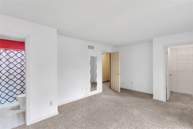 spare room featuring light colored carpet