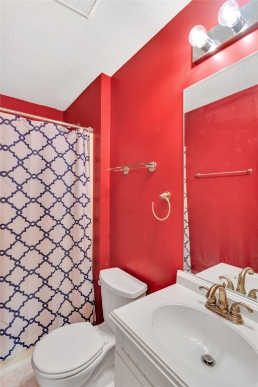 bathroom featuring tile patterned floors, walk in shower, vanity, and toilet