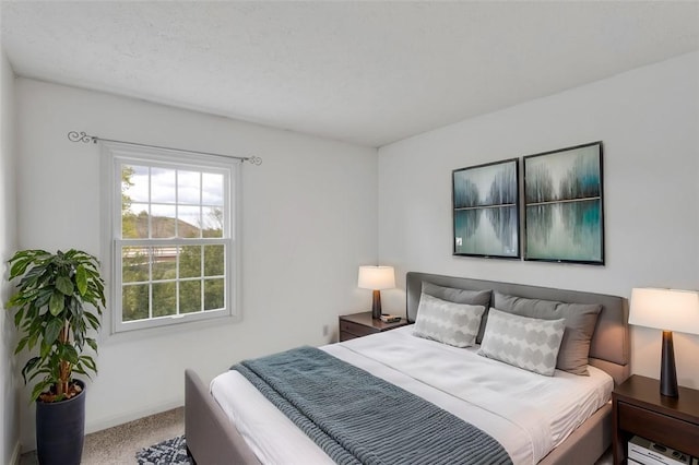 carpeted bedroom featuring a textured ceiling