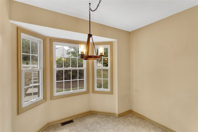 unfurnished dining area with light tile patterned floors and an inviting chandelier