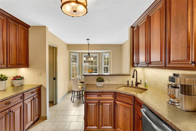 kitchen with light stone countertops, tasteful backsplash, stainless steel dishwasher, sink, and a chandelier