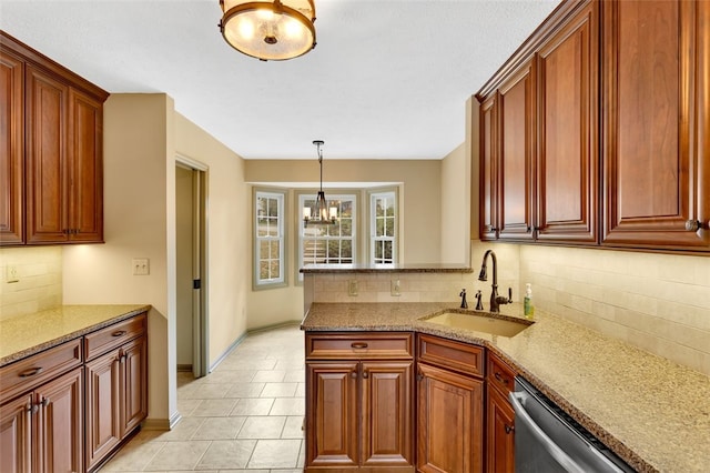 kitchen with backsplash, dishwasher, sink, and an inviting chandelier