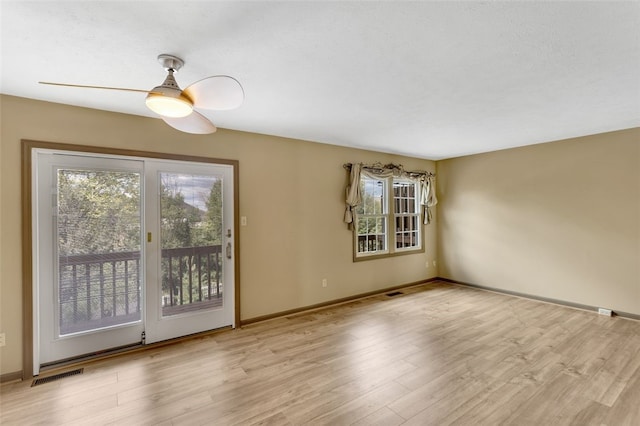 empty room featuring ceiling fan and light hardwood / wood-style floors