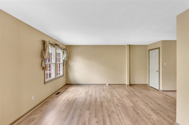 spare room with light wood-type flooring