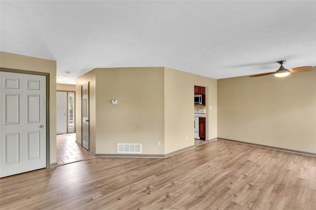 spare room with ceiling fan and light hardwood / wood-style flooring