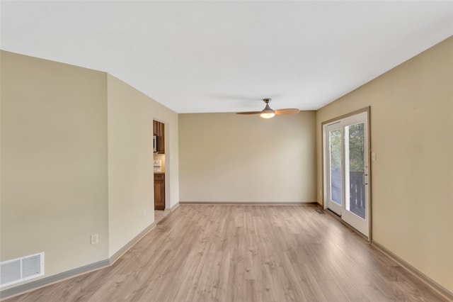 spare room featuring ceiling fan and light hardwood / wood-style floors