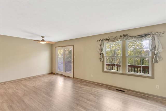 empty room featuring ceiling fan and light wood-type flooring