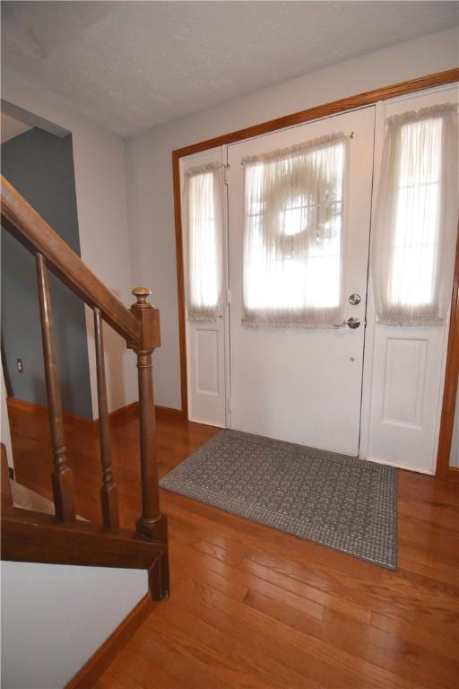 entrance foyer featuring hardwood / wood-style flooring and a textured ceiling