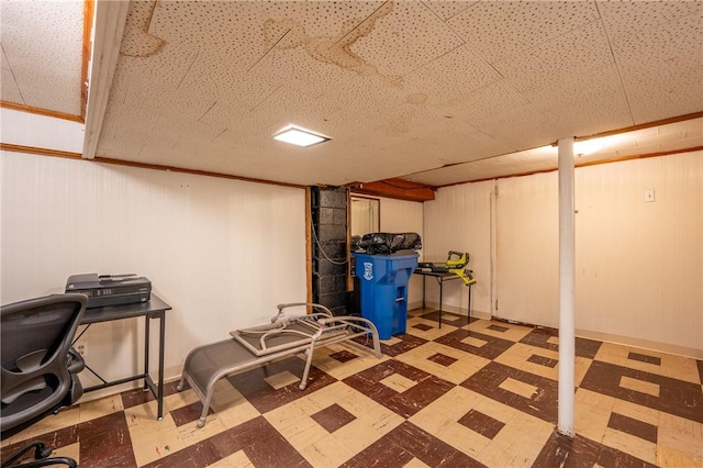 basement featuring wood walls