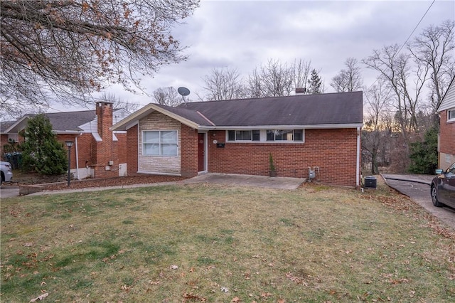 view of front of house with central air condition unit and a front lawn