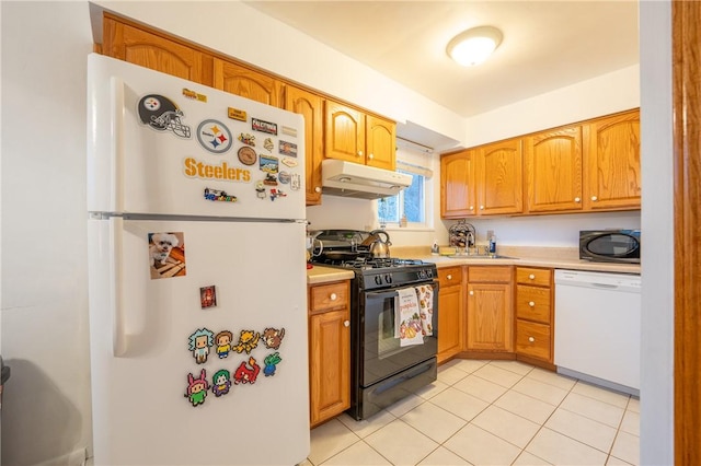 kitchen with light tile patterned floors, sink, and black appliances