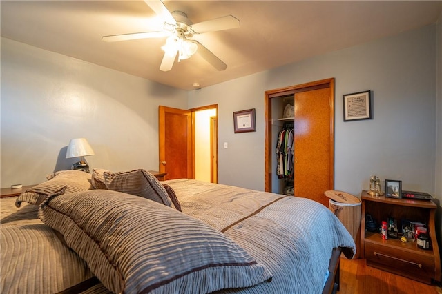 bedroom with a closet, ceiling fan, and dark hardwood / wood-style flooring