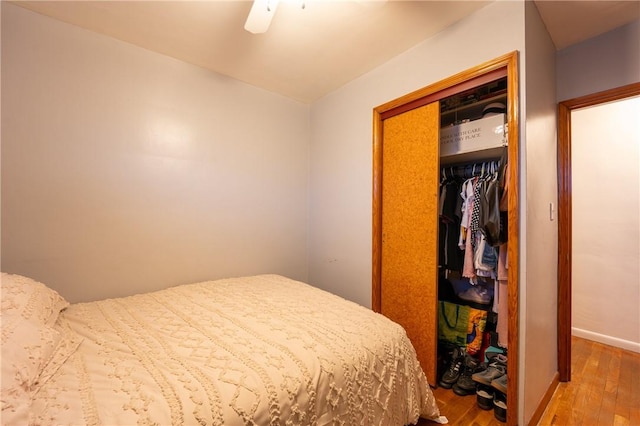 bedroom with hardwood / wood-style flooring, a closet, and ceiling fan