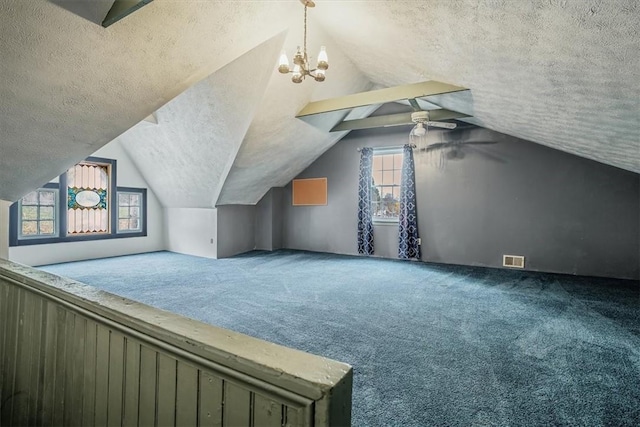 bonus room with carpet flooring, a textured ceiling, and vaulted ceiling