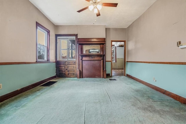 carpeted empty room with ceiling fan