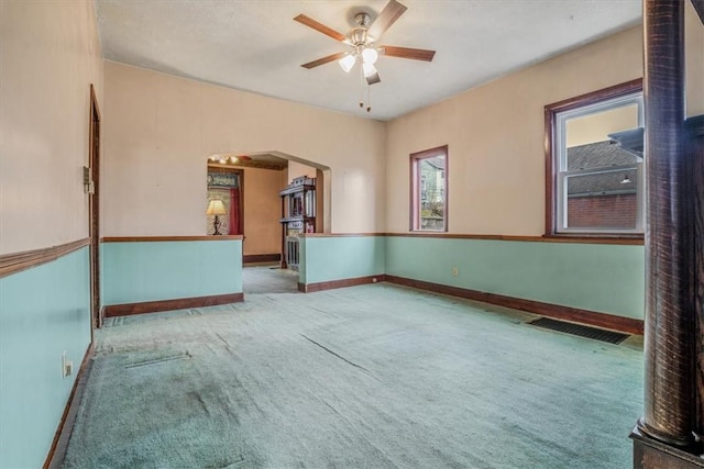 carpeted spare room featuring ceiling fan