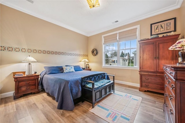 bedroom featuring light hardwood / wood-style floors and ornamental molding