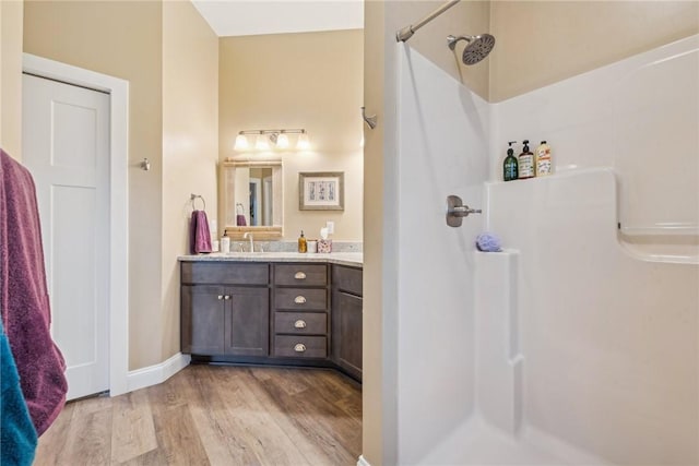 bathroom with vanity, a shower, and wood-type flooring