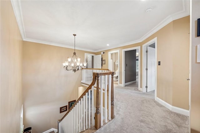 corridor featuring light colored carpet, an inviting chandelier, and crown molding