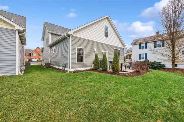 back of house with a yard, central AC unit, and a patio area