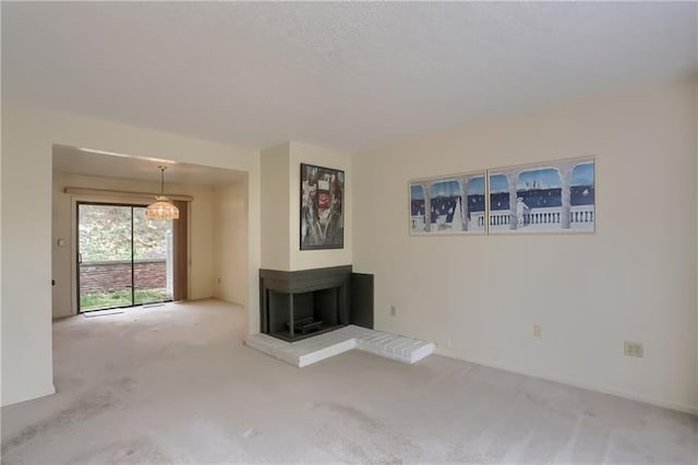 unfurnished living room with a multi sided fireplace and carpet floors