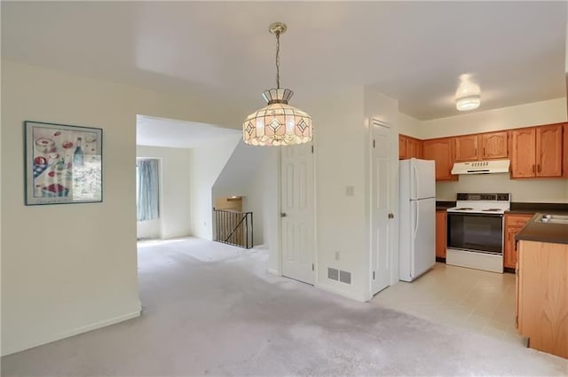 kitchen with light carpet, white appliances, and decorative light fixtures