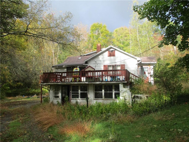 rear view of property with a wooden deck