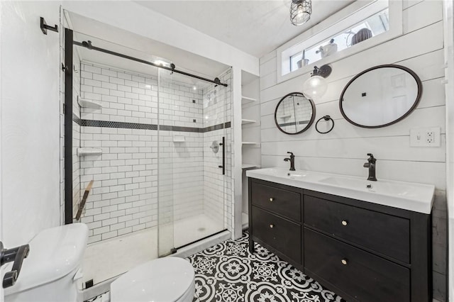 bathroom with vanity, toilet, and a shower with door