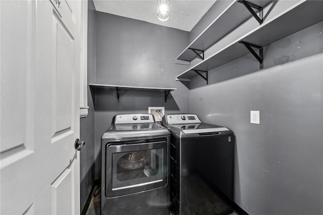 clothes washing area with independent washer and dryer