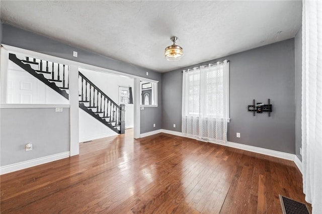 foyer entrance with a textured ceiling and hardwood / wood-style flooring