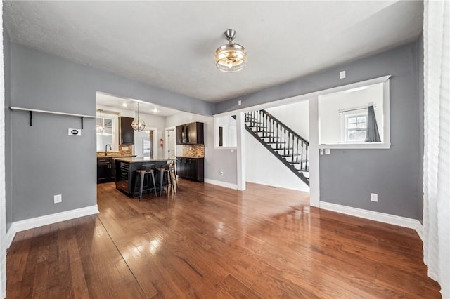 living room with sink and dark wood-type flooring