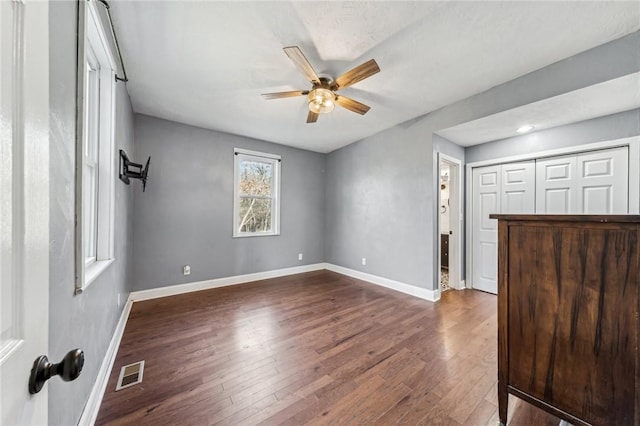 spare room featuring ceiling fan and dark hardwood / wood-style flooring