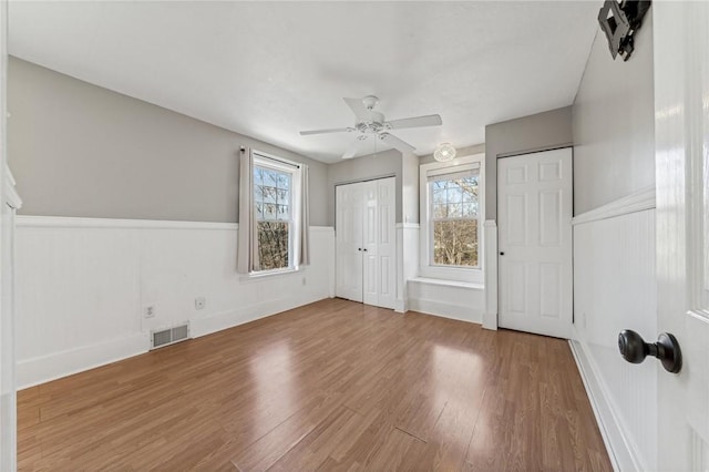 interior space featuring hardwood / wood-style flooring, plenty of natural light, and ceiling fan