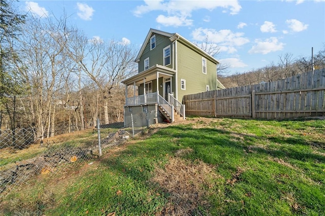 back of house with a lawn and a porch