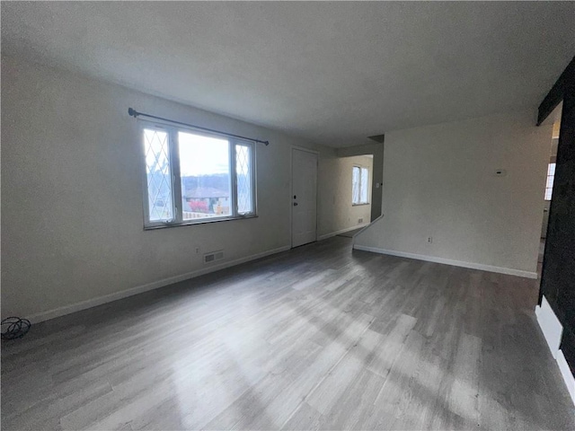 empty room featuring wood-type flooring and a textured ceiling