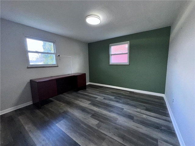 unfurnished room featuring dark hardwood / wood-style flooring