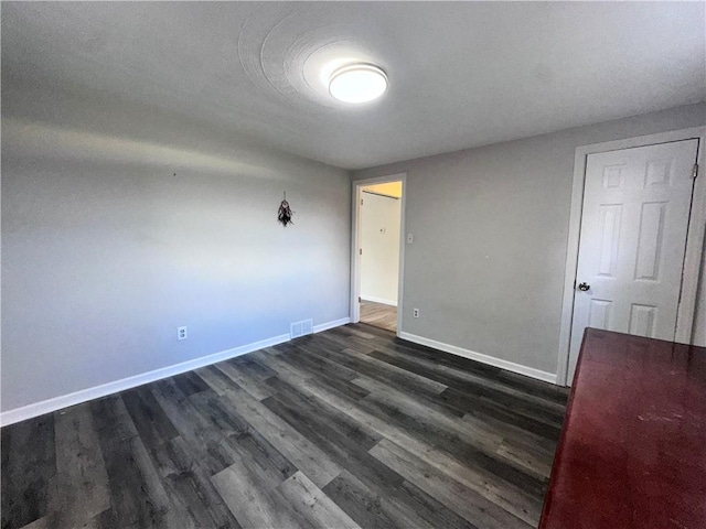 empty room featuring dark hardwood / wood-style flooring