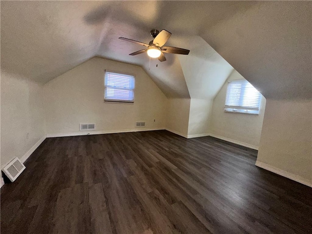 additional living space featuring dark hardwood / wood-style floors, ceiling fan, and lofted ceiling