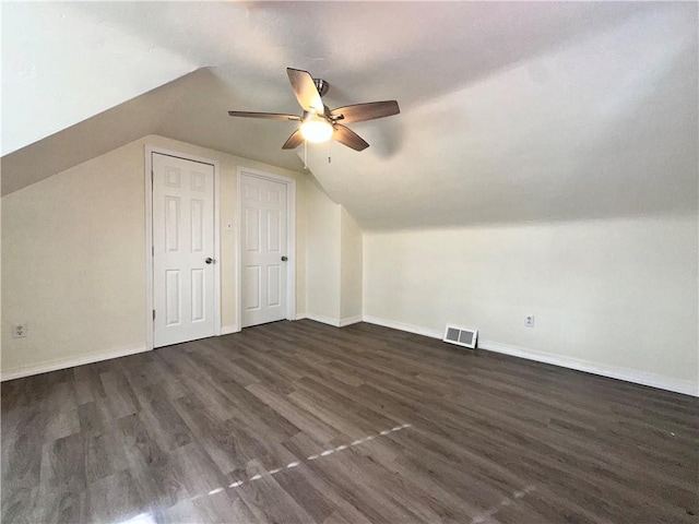 additional living space featuring ceiling fan, dark wood-type flooring, and vaulted ceiling