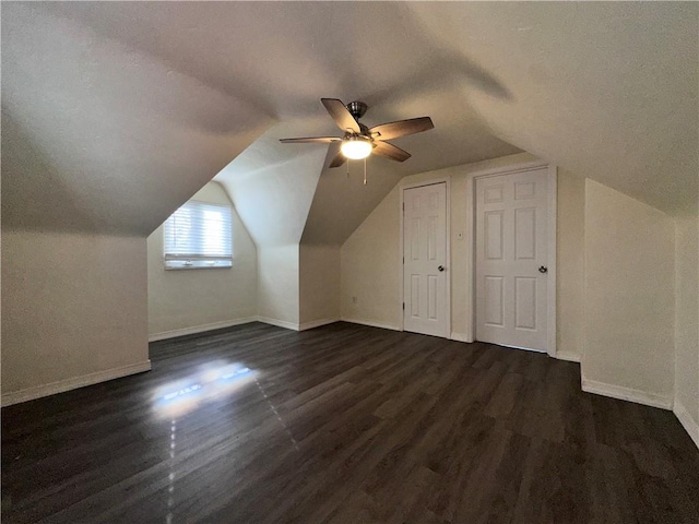 bonus room with ceiling fan, lofted ceiling, and dark wood-type flooring