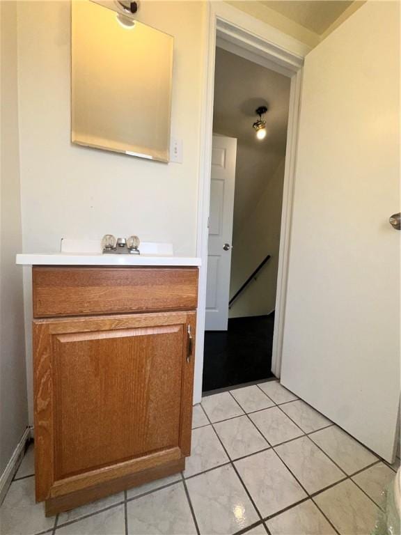 bathroom featuring tile patterned flooring and vanity