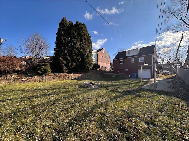 view of yard featuring a fire pit and a garage