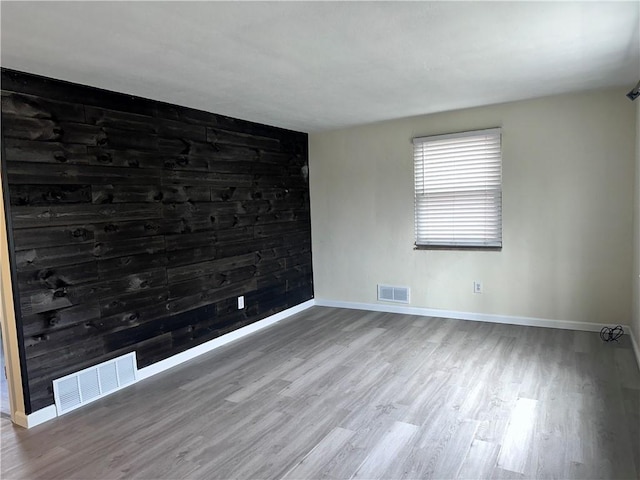 spare room with hardwood / wood-style floors