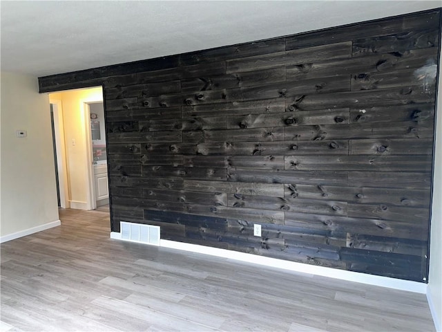 unfurnished room with light wood-type flooring