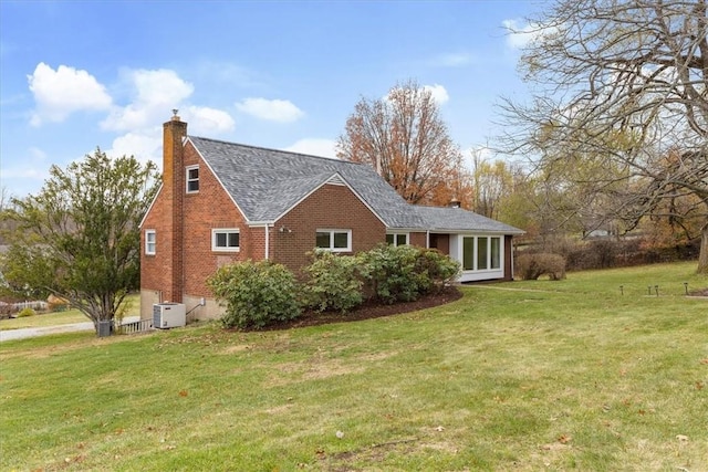 view of property exterior featuring a lawn and central AC unit