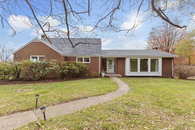 ranch-style home featuring a front yard