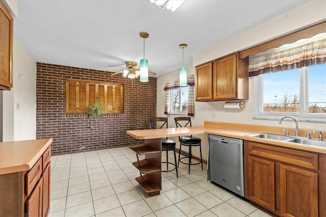 kitchen with ceiling fan, dishwasher, sink, brick wall, and plenty of natural light