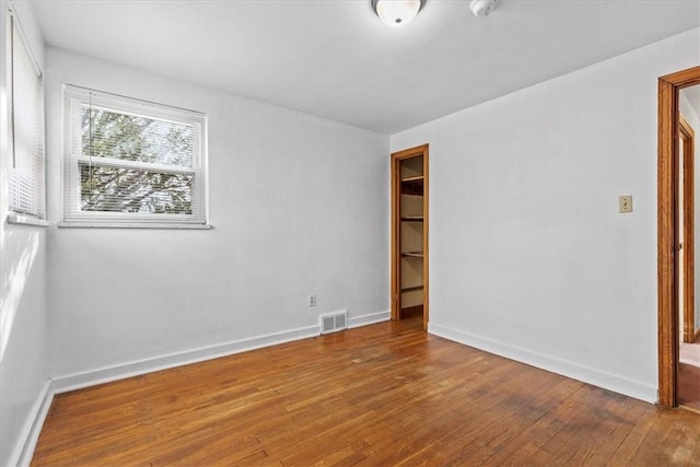 unfurnished room featuring wood-type flooring