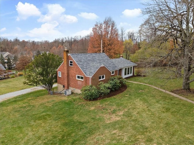 view of side of property with a lawn