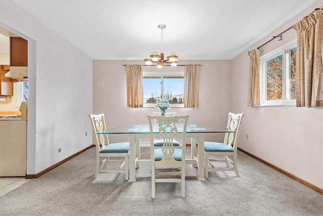 carpeted dining area featuring a notable chandelier